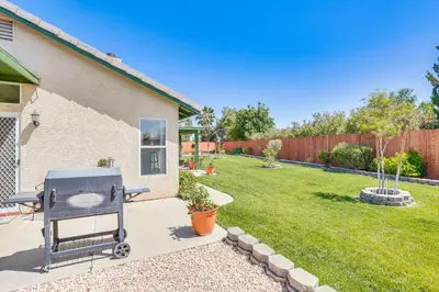 a barbecue grill sitting in the backyard of a house at Victorville Home with Large Yard and Charcoal Grill! in Victorville