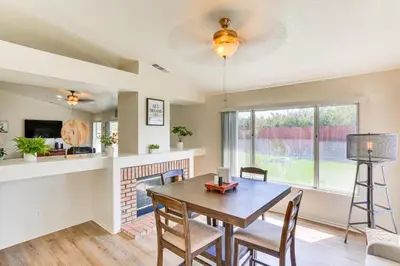 a dining room with a table and chairs and a fireplace at Victorville Home with Large Yard and Charcoal Grill! in Victorville