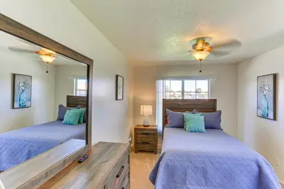 a bedroom with two beds and a mirror at Victorville Home with Large Yard and Charcoal Grill! in Victorville