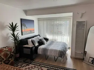 a bedroom with a bed in a room with a window at Carpinteria Beach Studio Condo in Carpinteria