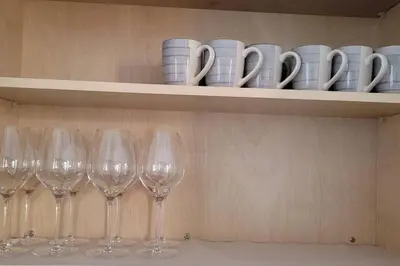 a row of wine glasses sitting on a shelf at H&H New Built 2023 Hidden Gem Heart of OC 3 Queen Beds in Westminster