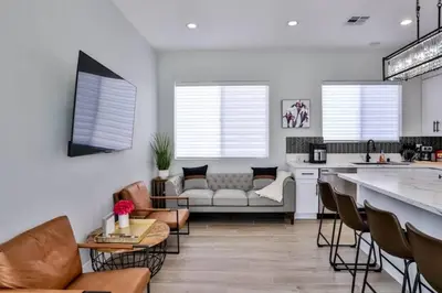a kitchen and living room with a couch and a table at H&H New Built 2023 Hidden Gem Heart of OC 3 Queen Beds in Westminster
