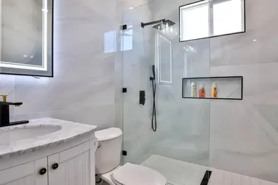 a bathroom with a shower and a toilet and a sink at H&H New Built 2023 Hidden Gem Heart of OC 3 Queen Beds in Westminster