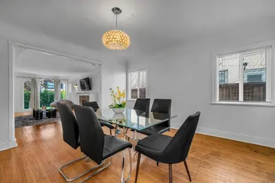 a dining room with a glass table and black chairs at Chic Charming 2-Bedroom with office in the WeHo in Los Angeles