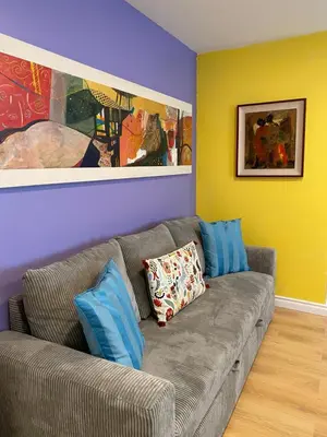 a living room with a gray couch with blue pillows at Pasadena Old Town in Pasadena