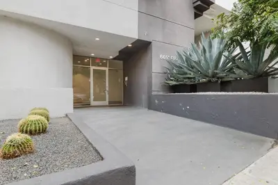 a building with two cacti in front of it at Blueground Hollywood gym near Walk of Fame LAX-1217 in Los Angeles