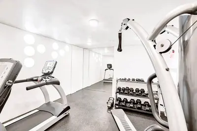 a gym with a treadmill and wine bottles at Blueground Hollywood gym near Walk of Fame LAX-1217 in Los Angeles