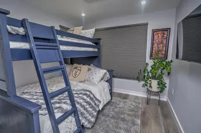a bedroom with a bunk bed and a blue ladder at Corner Haus Los Angeles in Los Angeles