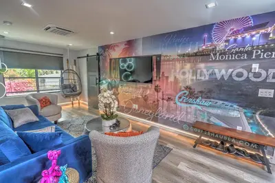a living room with a large mural on the wall at Corner Haus Los Angeles in Los Angeles