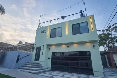 a white house with a garage in front of it at Corner Haus Los Angeles in Los Angeles