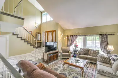 a living room with a couch and a television at Anaheim Home with Pool, 14 Mi to Disneyland! in Anaheim