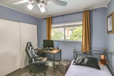 a bedroom with a bed and a desk with a computer at Anaheim Home with Pool, 14 Mi to Disneyland! in Anaheim