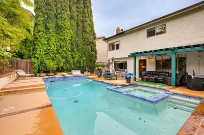 a large swimming pool in front of a house at Anaheim Home with Pool, 14 Mi to Disneyland! in Anaheim