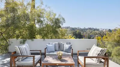 a patio with two chairs and a table at Hollywood Overlook by AvantStay Private Pool Hot Tub Panoramic Views in Los Angeles
