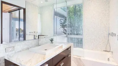 a white bathroom with a sink and a mirror at Hollywood Overlook by AvantStay Private Pool Hot Tub Panoramic Views in Los Angeles