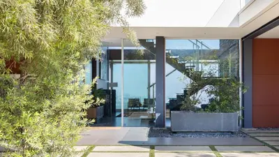 a glass house with a view of the water at Hollywood Overlook by AvantStay Private Pool Hot Tub Panoramic Views in Los Angeles