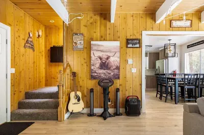 a room with wooden walls with a cow painting on the wall at Family Lake Arrowhead Home Sleeps 12 and Gameroom in Lake Arrowhead