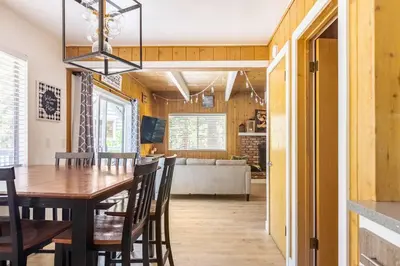 a dining room and living room with a table and chairs at Family Lake Arrowhead Home Sleeps 12 and Gameroom in Lake Arrowhead