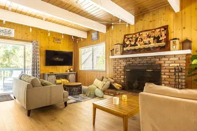 a living room with a couch and a fireplace at Family Lake Arrowhead Home Sleeps 12 and Gameroom in Lake Arrowhead