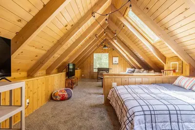 a bedroom with a bed in a wooden cabin at Family Lake Arrowhead Home Sleeps 12 and Gameroom in Lake Arrowhead