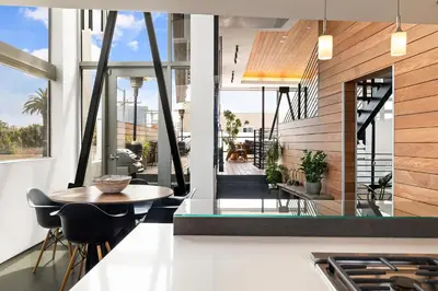 a kitchen with a table and chairs in a building at Venice Rooftop 5bd 4 bt steps from the beach in Los Angeles