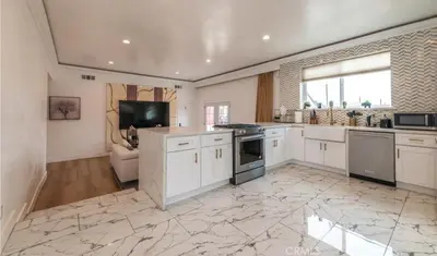 a large kitchen with white cabinets and a large window at Modern comfort private room 1 in Los Angeles