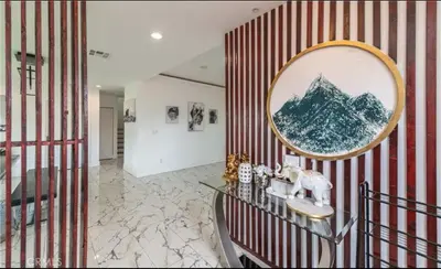 a living room with a red and white striped wall at Modern comfort private room 1 in Los Angeles