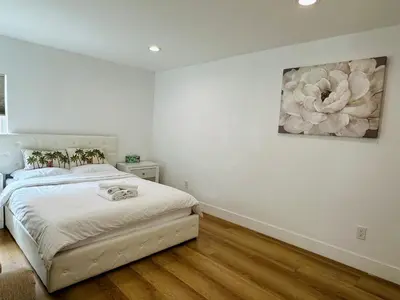a bedroom with a bed and a painting on the wall at Stylish Retreat Private Room 2 in Los Angeles