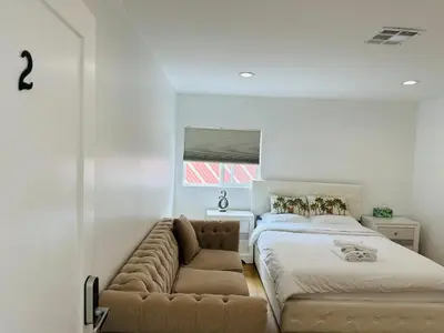 a bedroom with a couch next to a bed at Stylish Retreat Private Room 2 in Los Angeles