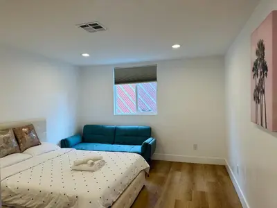a room with a bed and a couch in it at Cozy Haven private room 3 in Los Angeles