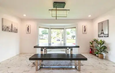 a dining room with a table and a large window at Charming Private Room 4 in Los Angeles