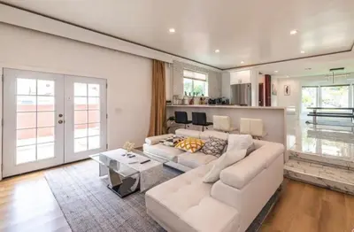 a living room with a white couch and a table at Chic and Secure Private room in modern home 6 in Los Angeles