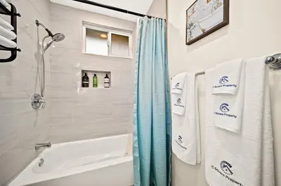 a bathroom with a tub and a shower with towels at Elegant Exclusive Escape In Downtown Los Angeles in Alhambra