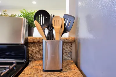 a metal container filled with utensils on a counter at Blissful Utopia near Downtown LA in Alhambra