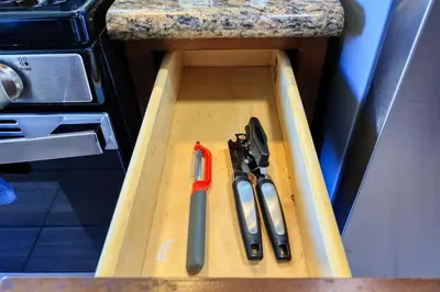 a cutting board with knives and scissors in a drawer at Blissful Utopia near Downtown LA in Alhambra