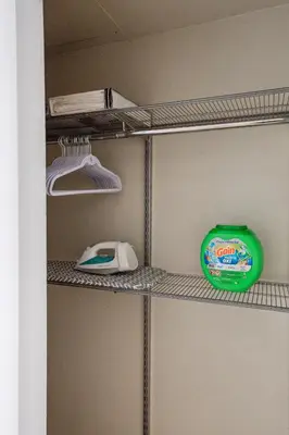a walk in closet with a phone and a green container at Comfy studio near SM Promenade! Free parking! in Los Angeles