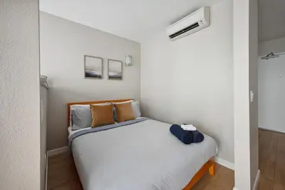 a small bedroom with a bed in a room at Comfy studio near SM Promenade! Free parking! in Los Angeles