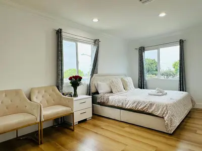 a bedroom with a bed and two chairs at Contemporary Private Room 7 in Los Angeles