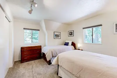 a bedroom with two beds and two windows at Natures Reserve in Lake Arrowhead