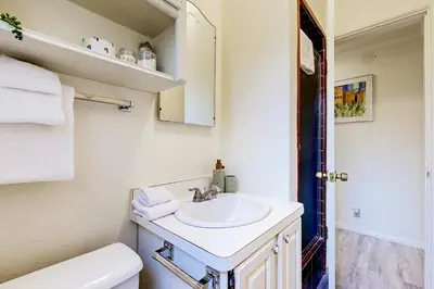 a white bathroom with a sink and a toilet at Natures Reserve in Lake Arrowhead