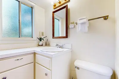 a white bathroom with a sink and a mirror at Natures Reserve in Lake Arrowhead