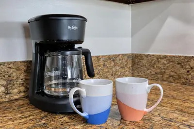 a coffee maker and two cups on a counter at Idyllic Paradise Near Downtown Los Angeles in Alhambra