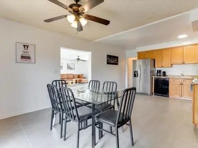 a dining room with a table and chairs and a kitchen at Charming 5 Bedroom Granada Hills House with Pool in Los Angeles