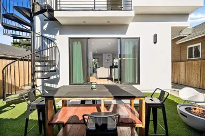 a patio with a table and chairs and a staircase at Rooftop 3B 3BA House Near Dodger Stadium and DTLA in Los Angeles