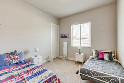 a bedroom with two beds and a window at Beautiful Bakersfield Home about 8 Mi to Downtown! in Bakersfield