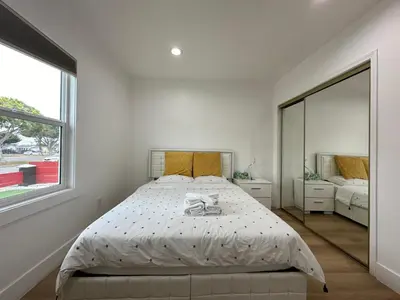 a white bedroom with a bed and a large window at Elegant Living Private Room in Modern Home 9 in Los Angeles