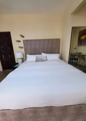 a bedroom with a large white bed with a headboard at Audrey Studio Apartment in Ktown in Los Angeles