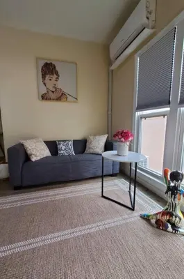 a living room with a blue couch and a table at Audrey Studio Apartment in Ktown in Los Angeles