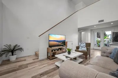 a living room with a couch and a tv at Modern 1-Bedroom Loft in Hollywood with Parking, WiFi & Hollywood Sign View in Los Angeles