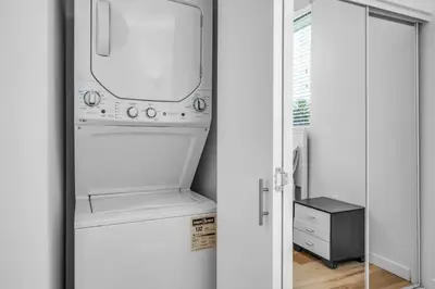 a kitchen with a washer and dryer in a refrigerator at Modern 1-Bedroom Loft in Hollywood with Parking, WiFi & Hollywood Sign View in Los Angeles